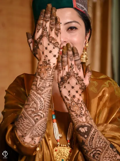A playful 'peek-a-boo' shot with the bride hiding behind her beautifully decorated hands.