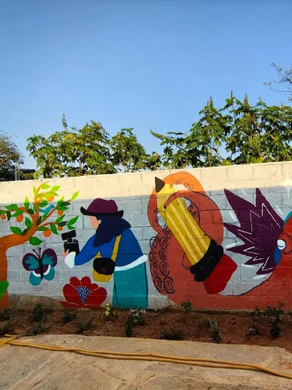 This part of the community mural shows characters representing creativity and nature, all brought to life by the hands of many.