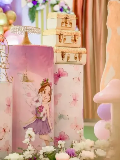 A close-up of the themed plinths and props from a butterfly party. We use details like vintage-style suitcases and a miniature Ferris wheel to add charm and character.