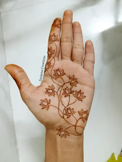 The first stage of a beautiful lotus vine design, showing the delicate outlines before they are filled.