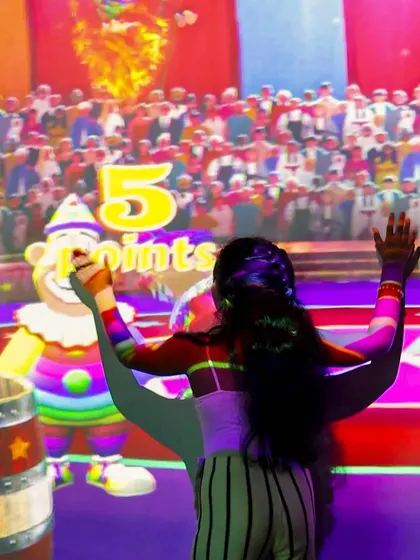 This girl is having a blast playing the interactive circus game on our giant projected wall.