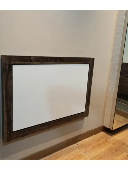 A wall-mounted study table in its folded-up position. When not in use, it sits flat against the wall, making it perfect for bedrooms or living areas where a permanent desk isn't practical.