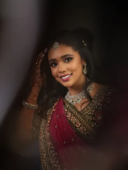 An artistic shot of Dr. Saruna, capturing her radiant smile. The lighting and composition create a beautiful and memorable portrait.