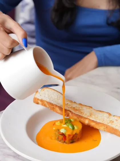 My monsoon menu features comforting dishes like this rich tomato pepper soup with basil cheese mousse and toasted focaccia.