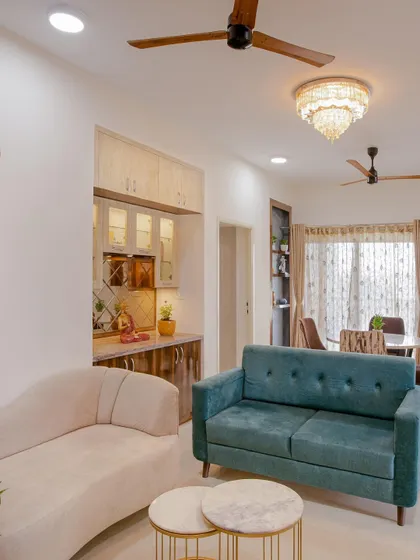 This Chennai home showcases beauty in simplicity. The living room features a mix of curved and straight-line sofas in contrasting colors, creating a dynamic yet harmonious look.
