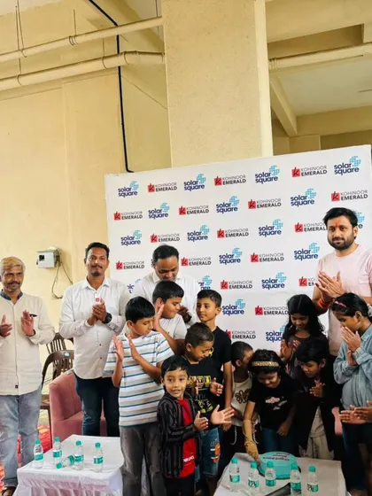Children at Kohinoor Emerald society in Pune gather for a cake-cutting ceremony to celebrate their new 20kW solar system.