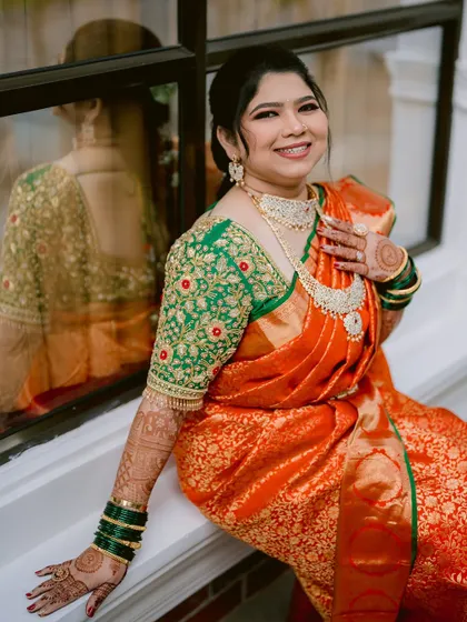 A happy portrait of the bride, Prerna, her smile radiant as she sits by the window.