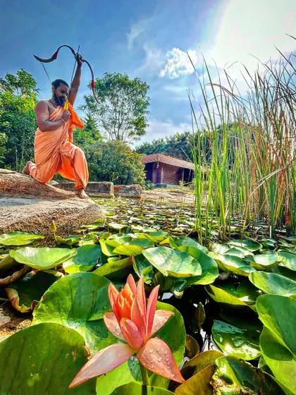 Like the lotus rising from the mud, a warrior finds mastery amidst challenges. This pose near the water lilies symbolizes the beauty and strength that emerges from disciplined practice of Dhanurvidya.