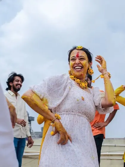 A bride dancing with joy during her Haldi ceremony. We focus on capturing the energy and happiness of these special pre-wedding rituals.