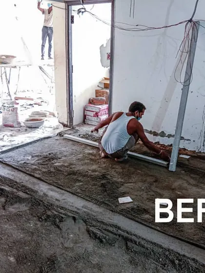 The "Before" stage of a flooring and civil work project. Our team is seen leveling the floor, which is a critical first step in any interior renovation to ensure a perfect finish.
