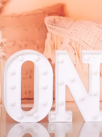 A close-up detail shot of the light-up "ONE" sign used in my studio for first birthday photoshoots. It's these little details that make the setup special.