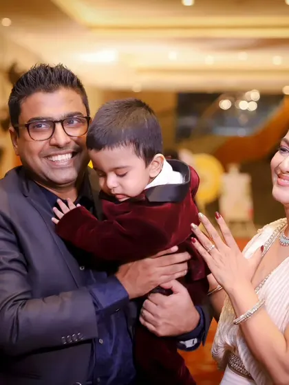 A father's gentle hold and a mother's loving gaze. These are the quiet, candid moments we preserve during busy family events.