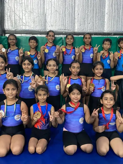 Our team of champions showing off their medals. The hard work and dedication of these gymnasts is truly inspiring.