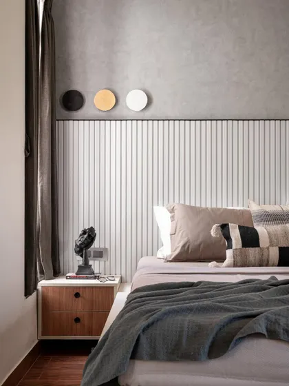 Another view of the master bedroom with the rafter headboard. The three-disc art piece above the bed adds a simple, graphic element to the textured grey wall.