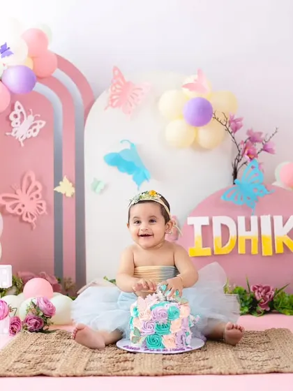 A butterfly-themed cake smash for a sweet one-year-old. The pastel colors and whimsical butterfly decorations make for an enchanting first birthday celebration.