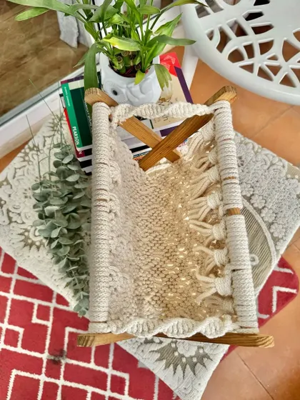 An overhead view of the magazine holder, showing the detailed knot work and tassels.