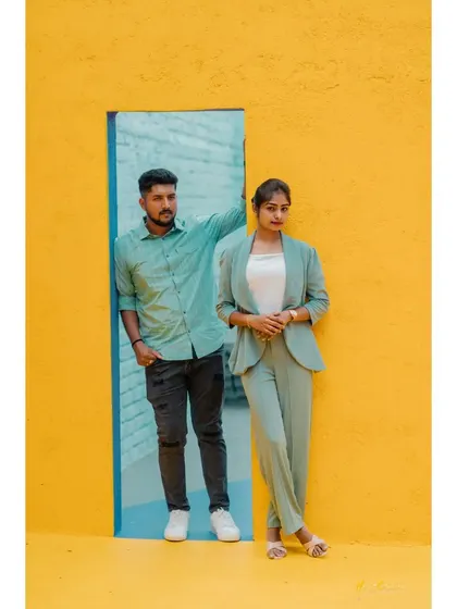 A cool and contemporary pose against a bright yellow wall with a contrasting blue doorway. This shows off a fun and fashionable side.