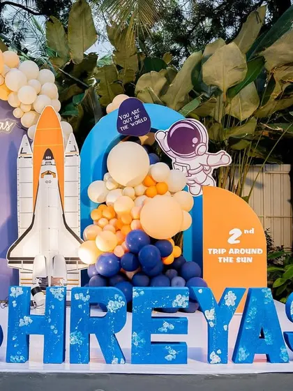 An out-of-this-world space-themed birthday party. We used a color palette of blue and orange, with custom astronaut and rocket props, to create an exciting adventure.