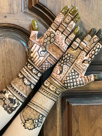 A gorgeous semi-bridal design with peacocks, elephants, and lotus motifs. It provides significant coverage without being a full bridal, ideal for a sangeet or reception.