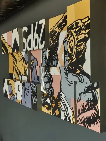 An angled shot of the Lounge29 pop art piece, showing how the different canvas depths create a 3D effect on the wall. This kind of custom wall decor adds a unique architectural element to a room.