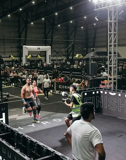 I believe in leading from the front, and that means stepping into the arena myself. Here I am at a Hyrox competition, pushing through the pain because that's where growth happens. This is the intensity and strategic mindset I bring to my own training and to every athlete I coach.