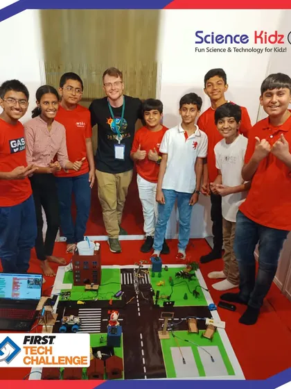 Our FIRST Tech Challenge team proudly posing with a guest at the India Championship 2023. They were delighted to demonstrate their "Soul City" project to visitors.