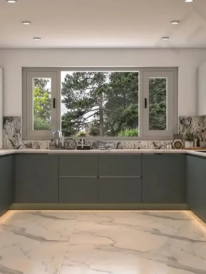 A spacious U-shaped kitchen with grey handle-less cabinets, a marble-patterned backsplash, and under-cabinet lighting for a bright workspace.