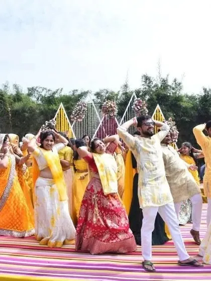 The whole family striking a pose at the end of their Haldi flash mob. These performances are less about perfection and more about having fun together as a family.