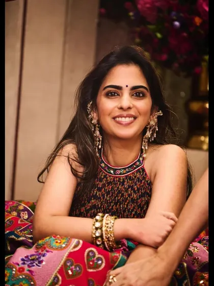 A candid moment with my client in a beautiful printed halter-neck outfit by Torani, accessorized with statement earrings and stacked bangles for a bohemian-luxe feel.