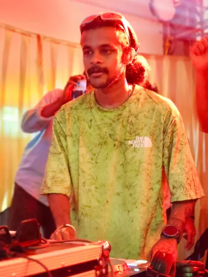 A focused shot of me at the decks during a live college show.