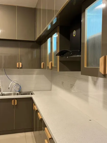 We did this 3 BHK for 13 Lakhs, including this sleek, modern kitchen with glossy cabinets, custom wooden handles, and all appliances. Luxury can be affordable.