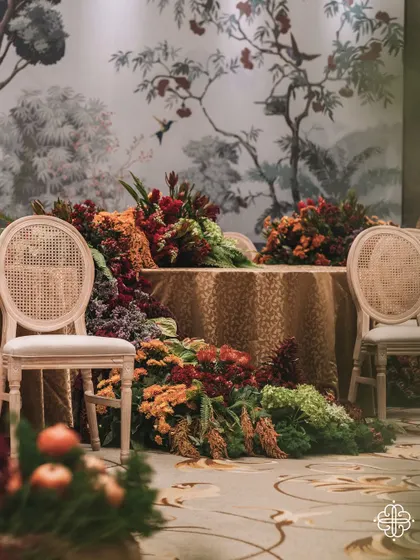 A floral runner cascades between two tables at the 'Orchard of Life' naming ceremony, creating a sense of overflowing abundance.