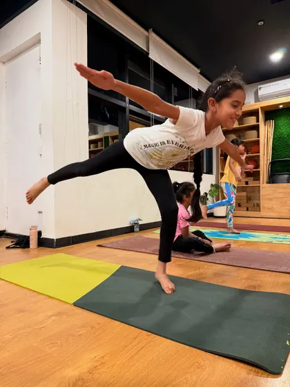 Finding balance and grace in Virabhadrasana III, or Warrior III pose. This young student shows amazing focus and strength, which are key benefits of a consistent yoga practice.