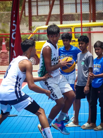 Players jostle for position in the paint, a common sight in our competitive JBL games. I teach athletes how to be strong and effective around the basket.