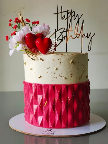 A repeat of a favorite design, this birthday cake features a bold red geometric texture on the bottom tier. It's a testament to how a great design can be loved by many.