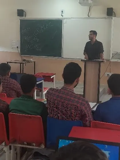 An instructor at a podium leads a session on cybersecurity, explaining key concepts to the students.