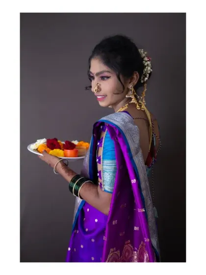 Another angle from our traditional Maharashtrian shoot. This side profile captures the elegance of the nath (nose ring) and the delicate details of the jewelry, set against a clean, dark background to emphasize the subject.