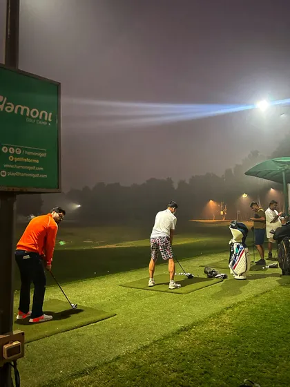 Practicing through the evening fog under the bright floodlights creates a unique and focused atmosphere.