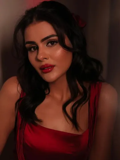 A close up portrait of Priyanka, looking bold, fierce, and stunning. The red lip is the star of this look.