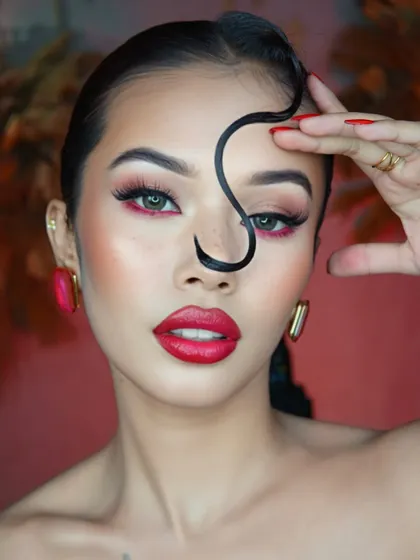 A different angle of our bold crimson waterline look, showcasing the sculpted cheekbones and flawless skin finish.