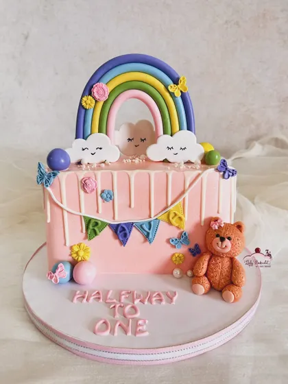 Another adorable half birthday cake, this one with a rainbow, teddy bear, and butterflies for baby Raya.