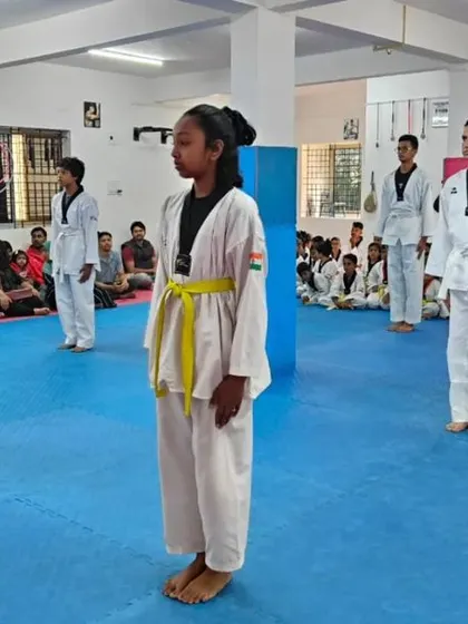 A line of yellow belts standing at attention.