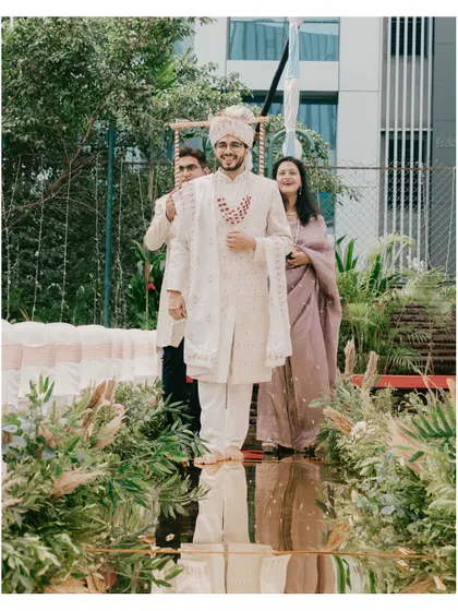The groom's grand entrance, walking down a mirrored aisle reflecting the sky above.