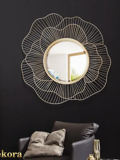A modern take on a floral mirror, this piece features a delicate wireframe design in a gold finish. It looks particularly striking against a dark, dramatic wall.
