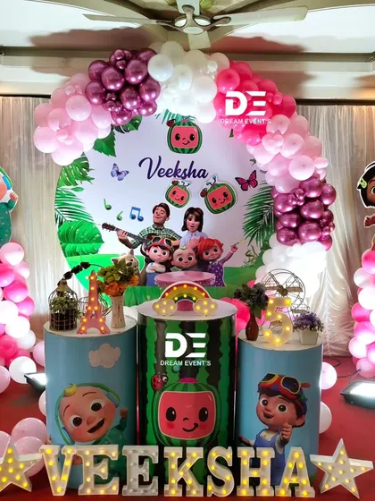 A sweet pink Cocomelon theme for Veeksha's birthday. This setup shows that the popular theme can be customized with different color palettes to suit your preference.