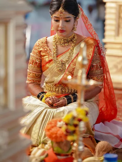 A candid shot of a bride during her wedding ceremony, adorned in our complete traditional gold jewellery set. The antique finish gives it a timeless, heirloom quality.