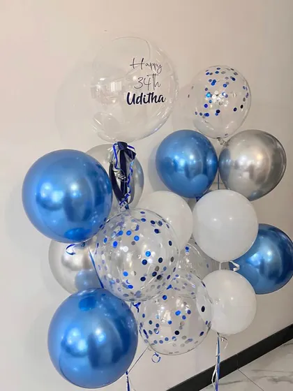 You're never too old to celebrate with balloons. This birthday bunch for a 34th birthday uses a cool palette of chrome blue, silver, and white, with a personalized bubble balloon.