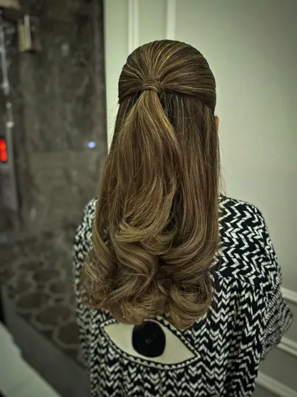 A simple and sleek half-up style with a neat twist.