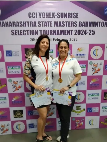 Two champions from our academy, Naheed Divecha and her partner, proudly displaying their medals and certificates after winning the Women's Doubles 50+ category.