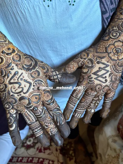 A close-up of the palms from the previous design, showing the 'Z' and 'Z' initials and the name 'Zikra' in Arabic.